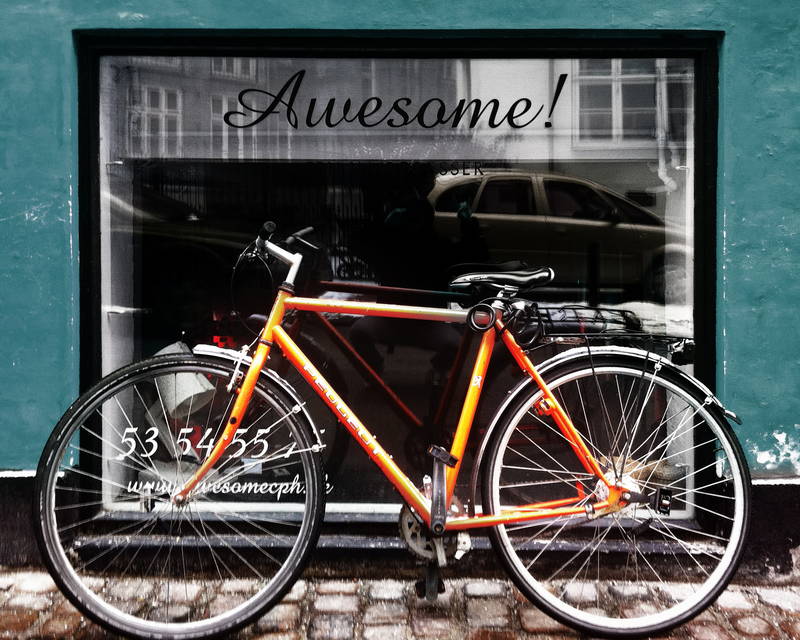Awesome orange vintage bike in front of window leaning up against wall. Stock Photography Free for Commercial Use.