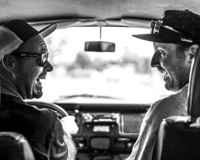 Van road trip in vintage van with two friends smiling in black and white. Stock Photography Free for Commercial Use.