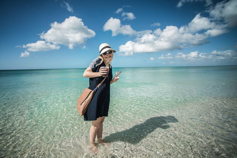 Beautiful woman on beach in blue water. Stock Photography Free for Commercial Use.